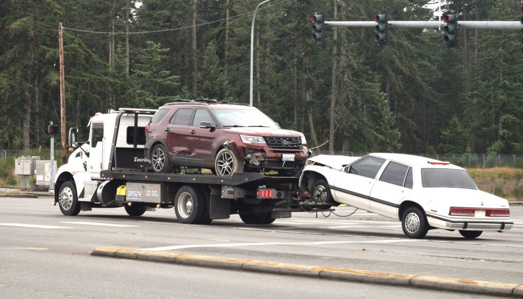 Tow truck towing a junk car